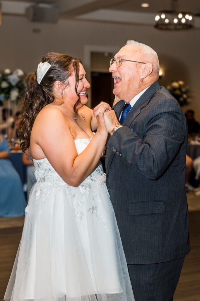 The bride laughs as she shares a dance with her grandpa at the Estate at New Albany