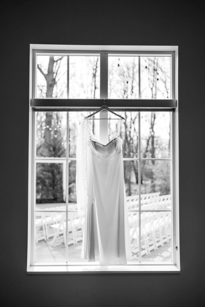 Wedding dress hanging in a window