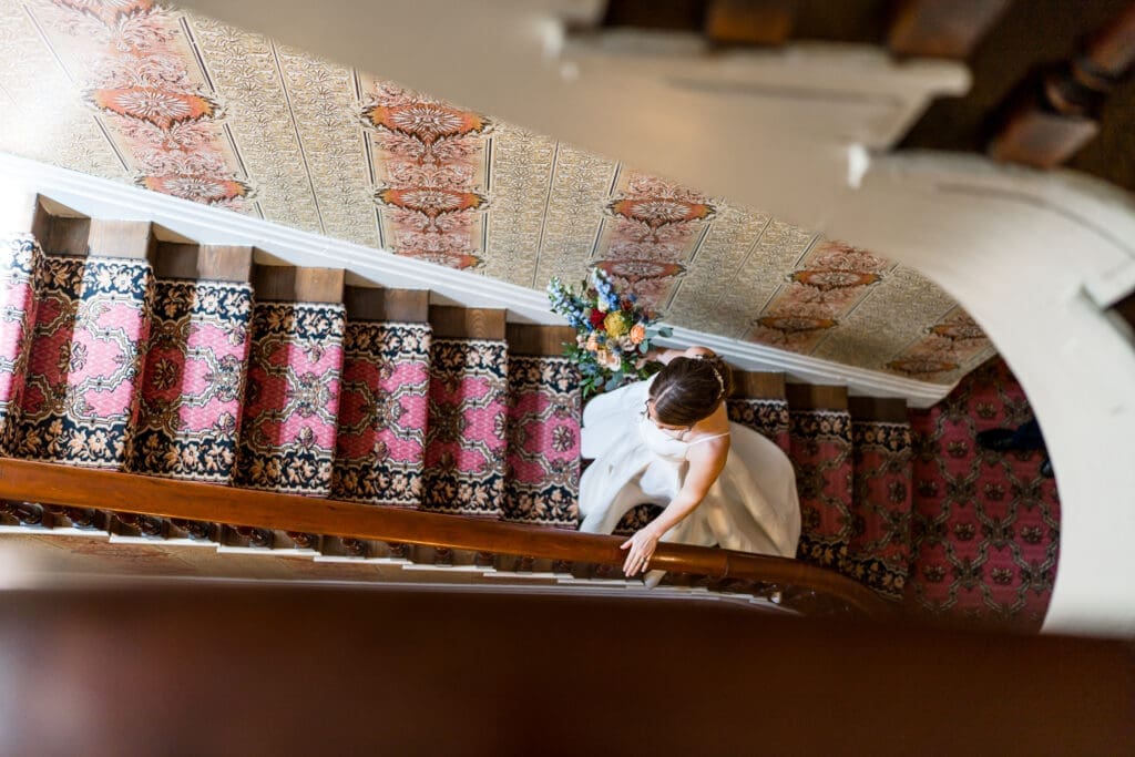 Creative staircase photo of the bride walking up the stairs at the Kelton House in Columbus, Ohio