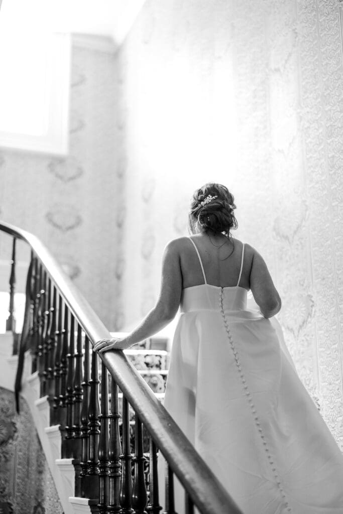 Bride walking up a staircase at the Kelton House in Columbus, Ohio