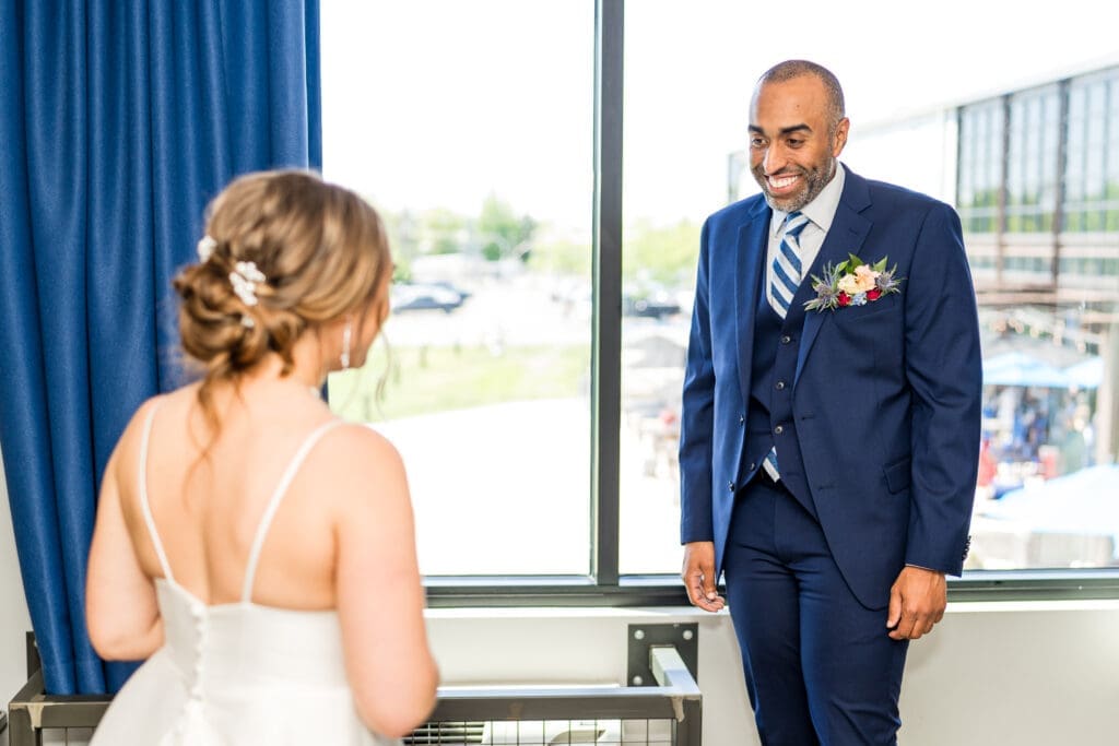Bride and groom first look in their hotel room