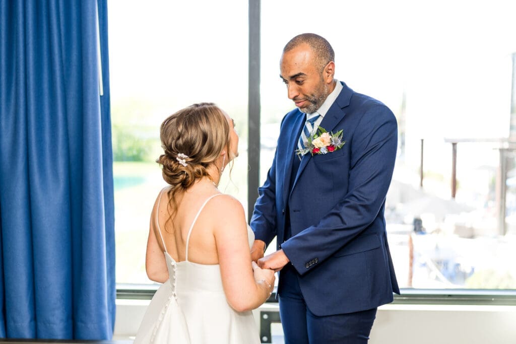 Bride and groom first look in their hotel room