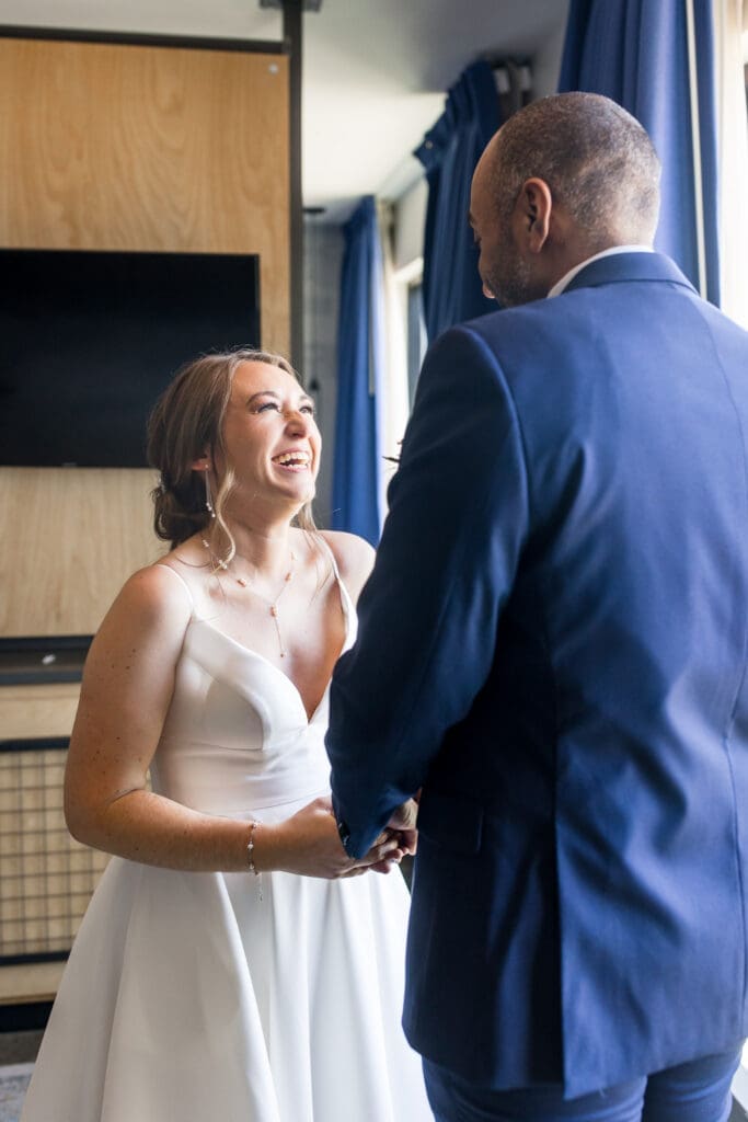 Bride and groom first look in their hotel room