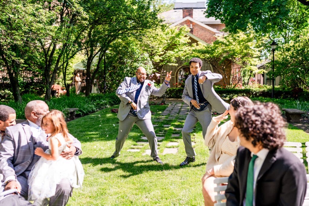 Flower men with fanny packs dancing down the aisle at the Kelton House in Columbus, Ohio.