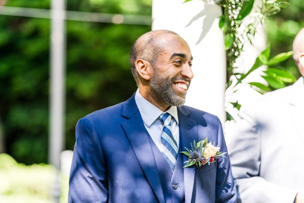 The groom's reaction as he sees his bride walking down the aisle