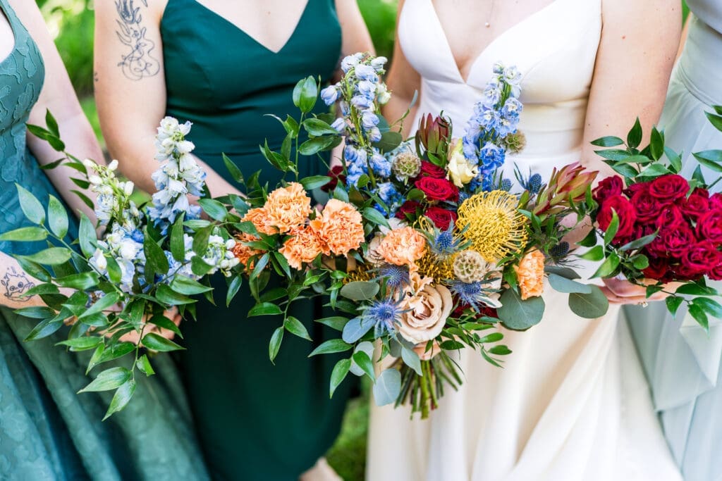 Colorful wildflower bouquets with the bridesmaids dressed in shades of green.