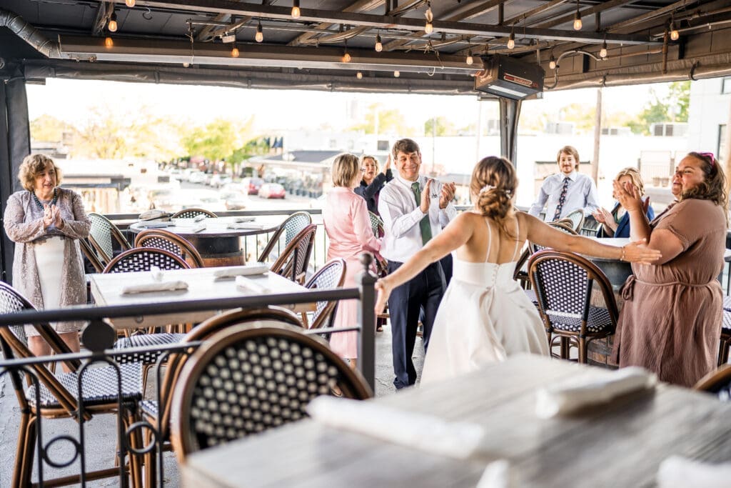 Guests clap as they see the bride enter at the Grandview Cafe
