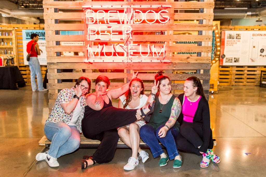 The bride and her friends make a silly pose in the beer museum at BrewDog in Canal Winchester, Ohio.