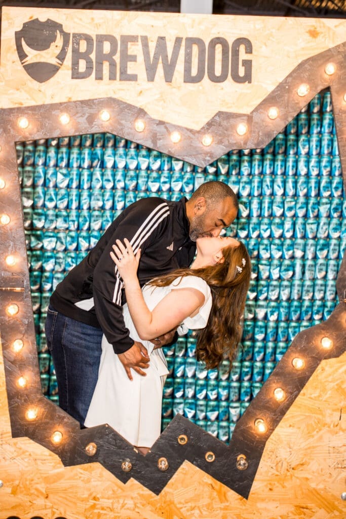 Bride and groom dip kiss in a photo booth at BrewDog in Canal Winchester, Ohio