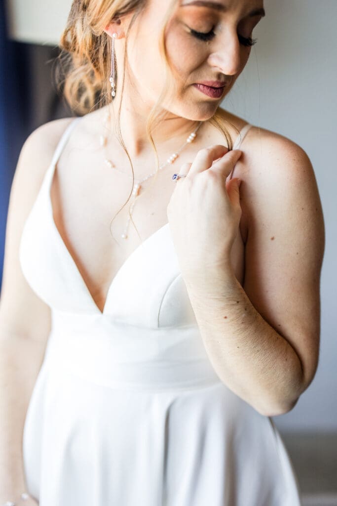 Detail photos of the bride's dress, makeup, and jewelry.