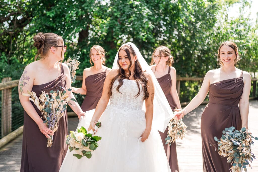 The bride and her bridesmaids dressed in brown at the Columbus Zoo and Aquarium