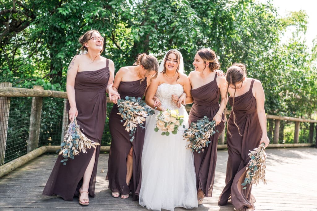 The bride and her bridesmaids dressed in brown at the Columbus Zoo and Aquarium