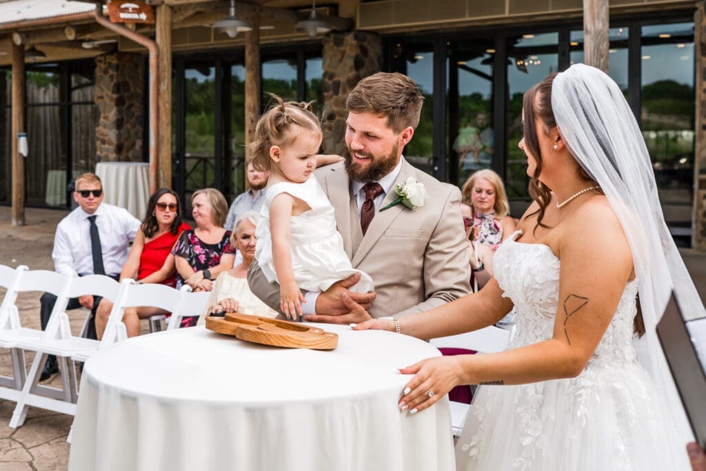 The bride and groom put a puzzle together for their unity ceremony with their daughter at the Columbus Zoo and Aquarium