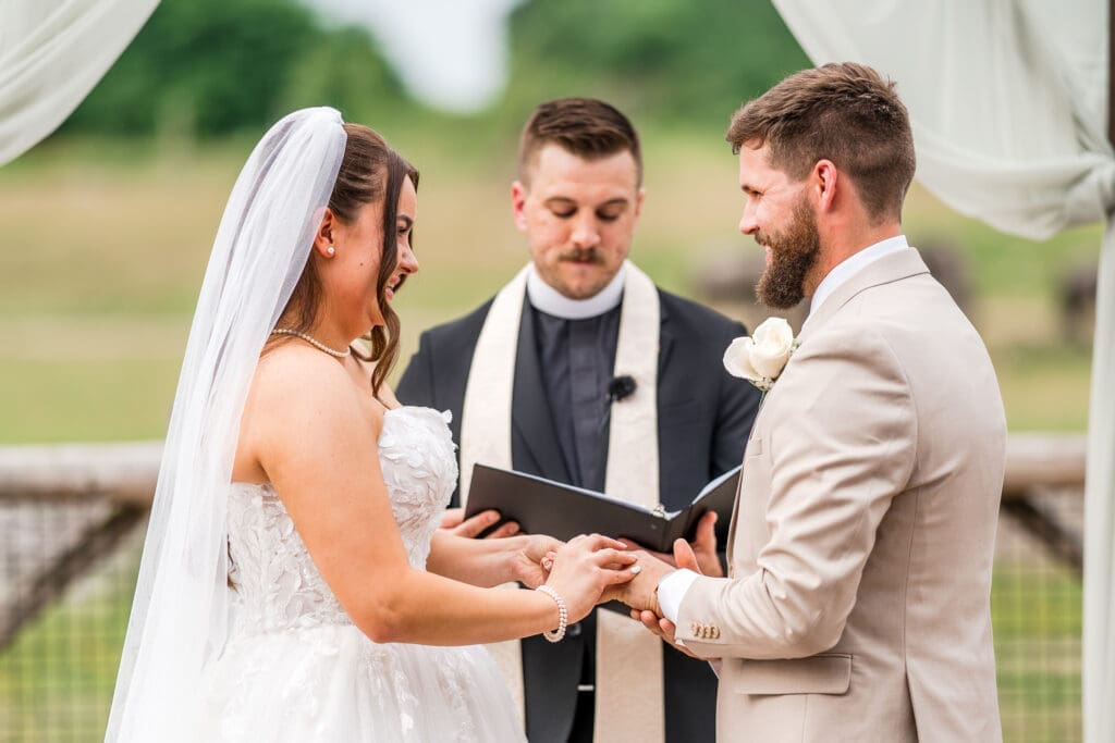 Exchanging rings during a wedding ceremony at the Columbus Zoo and Aquarium