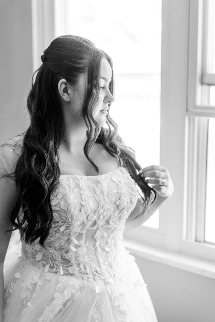 Bridal portrait of the bride looking out the window