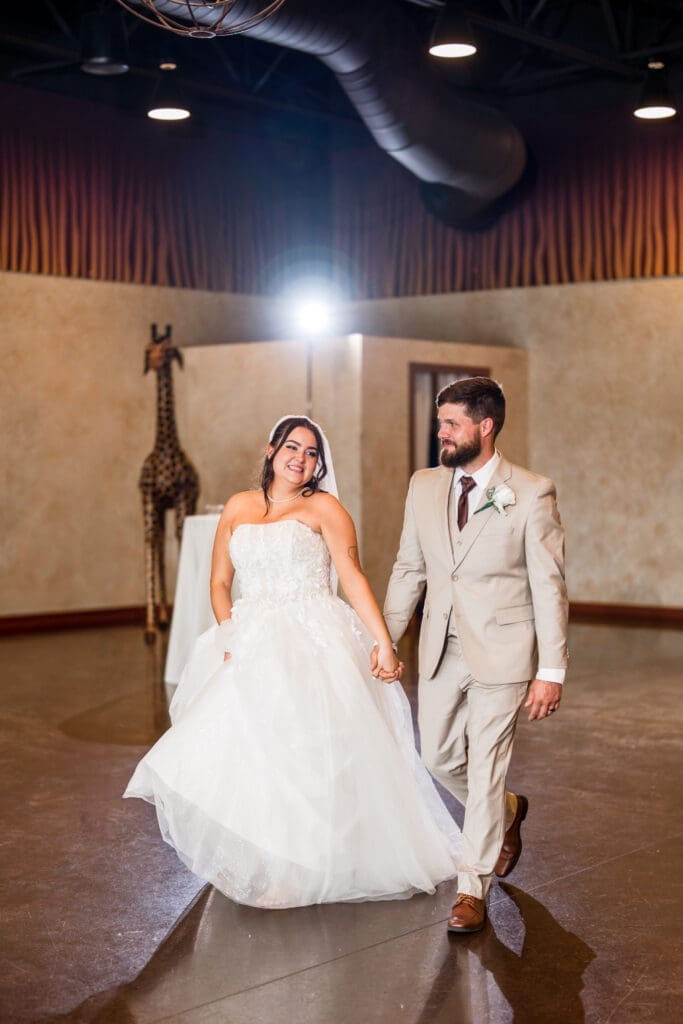 The bride and groom enter their wedding reception at the Columbus Zoo and Aquarium Africa Event Center