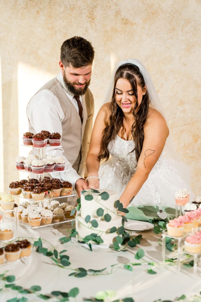 The bride and groom cut the cake at the Columbus Zoo and Aquarium