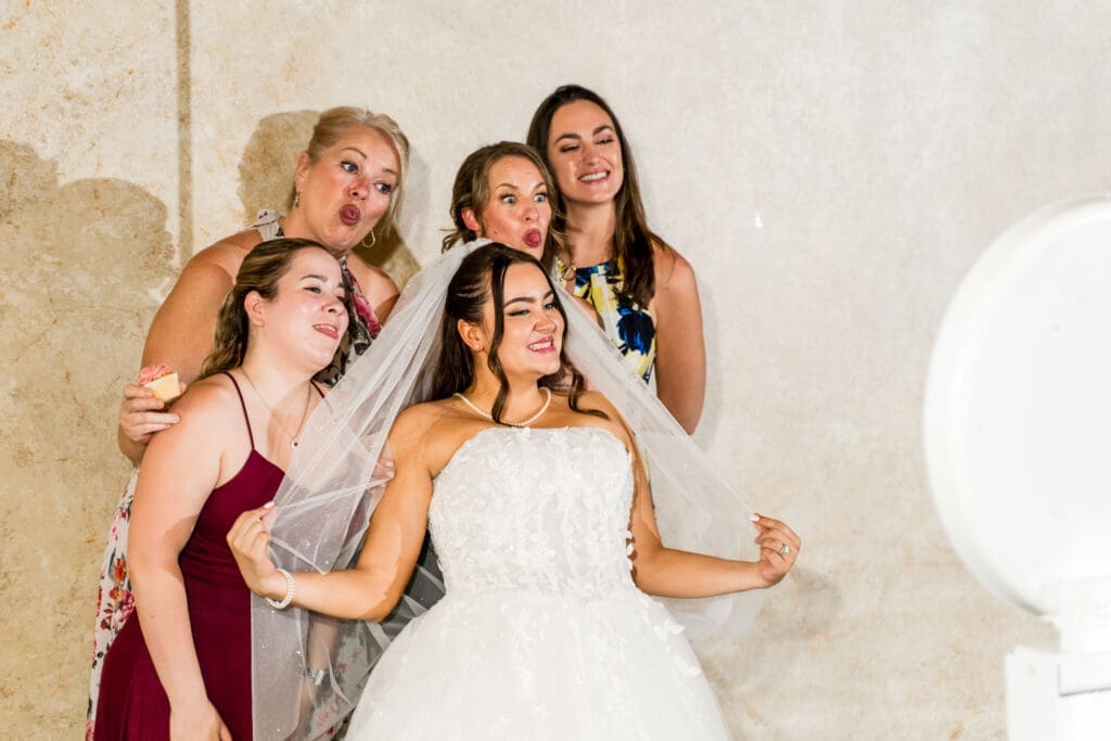 The bride and her friends pose for the photobooth