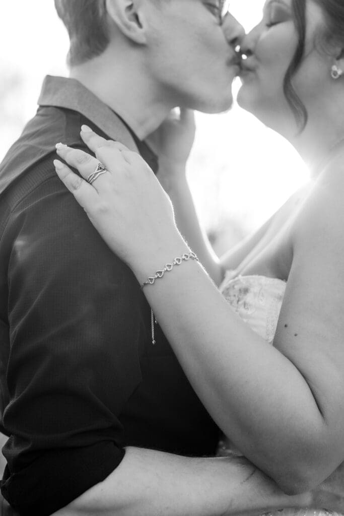The bride and groom share a kiss at golden hour