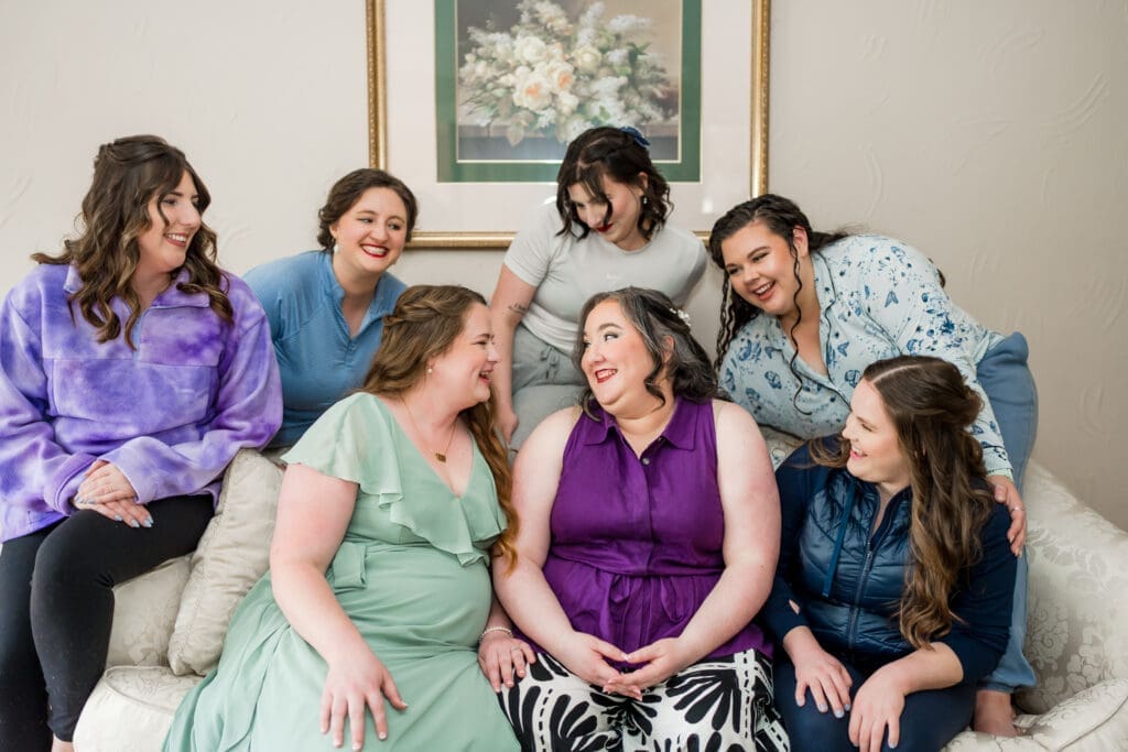 The bride and her bridesmaids look at each other and laugh at the Dempsey Event Center in Delaware, Ohio.