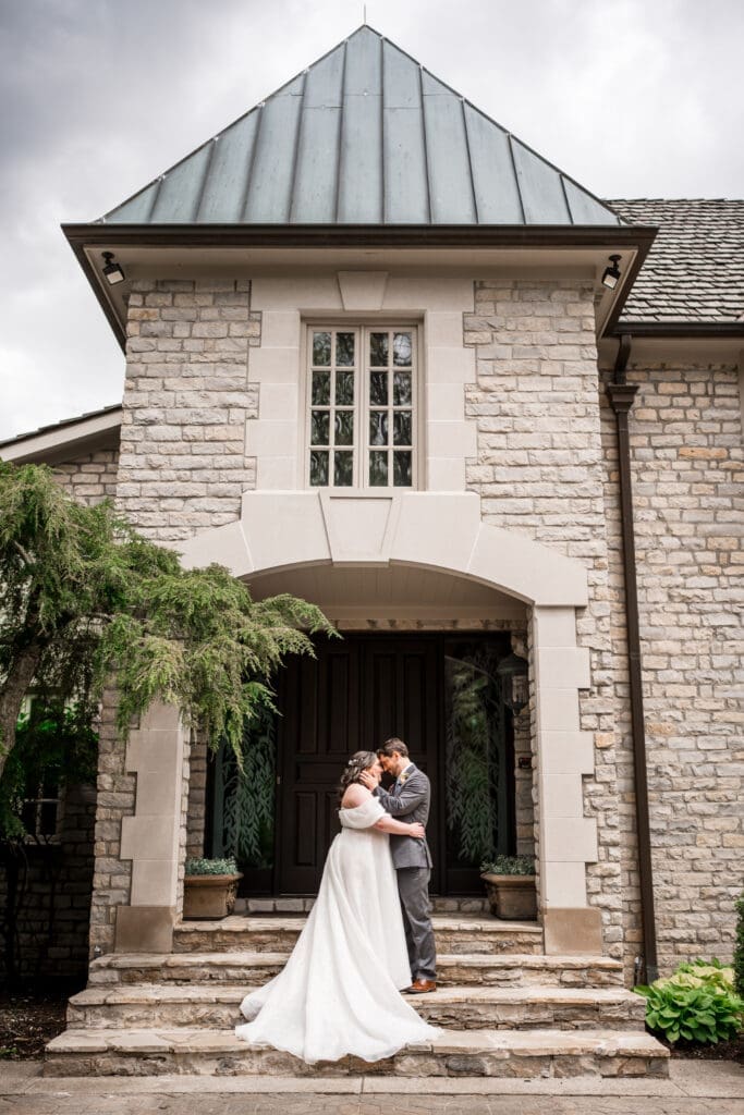Wedding couple portrait in front of the mansion at the Dempsey Event Center in Delaware, Ohio.