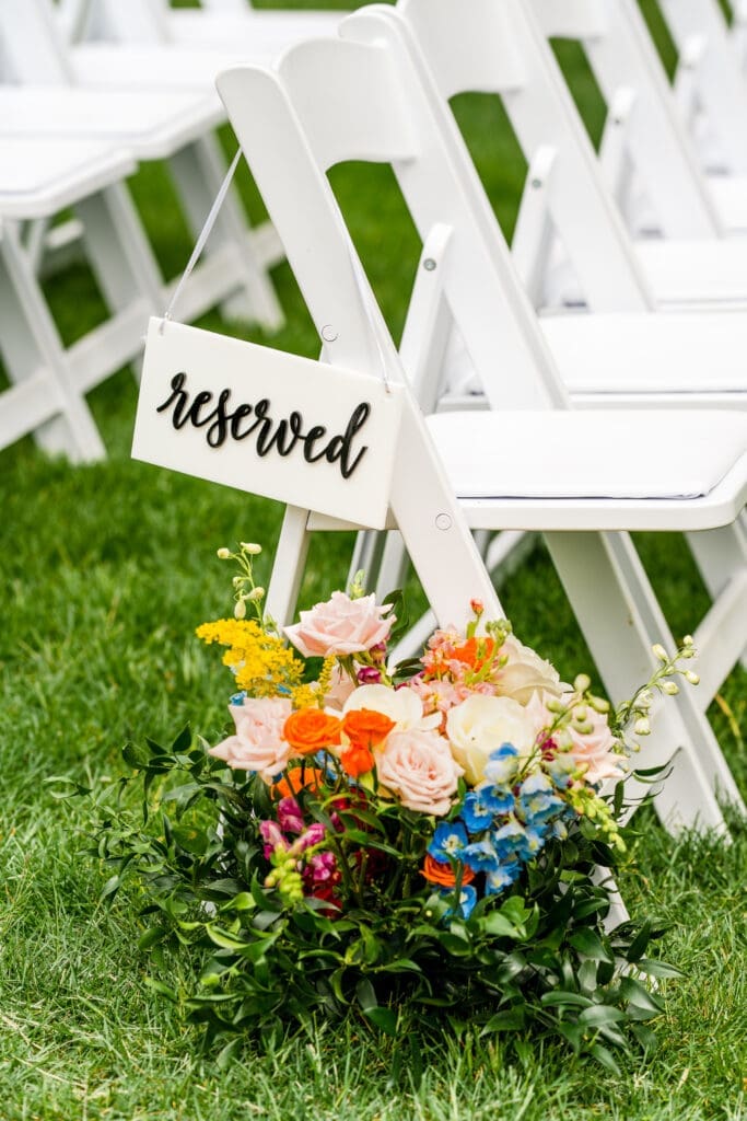 Reserved seating row with colorful wildflower arrangement at the Dempsey Event Center in Delaware, Ohio.