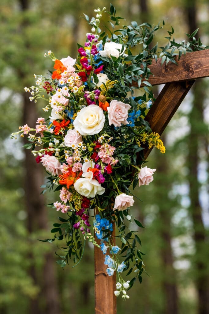 Colorful wildflower swag on the corner of a wooden arch at the Dempsey Event Center in Delaware, Ohio.