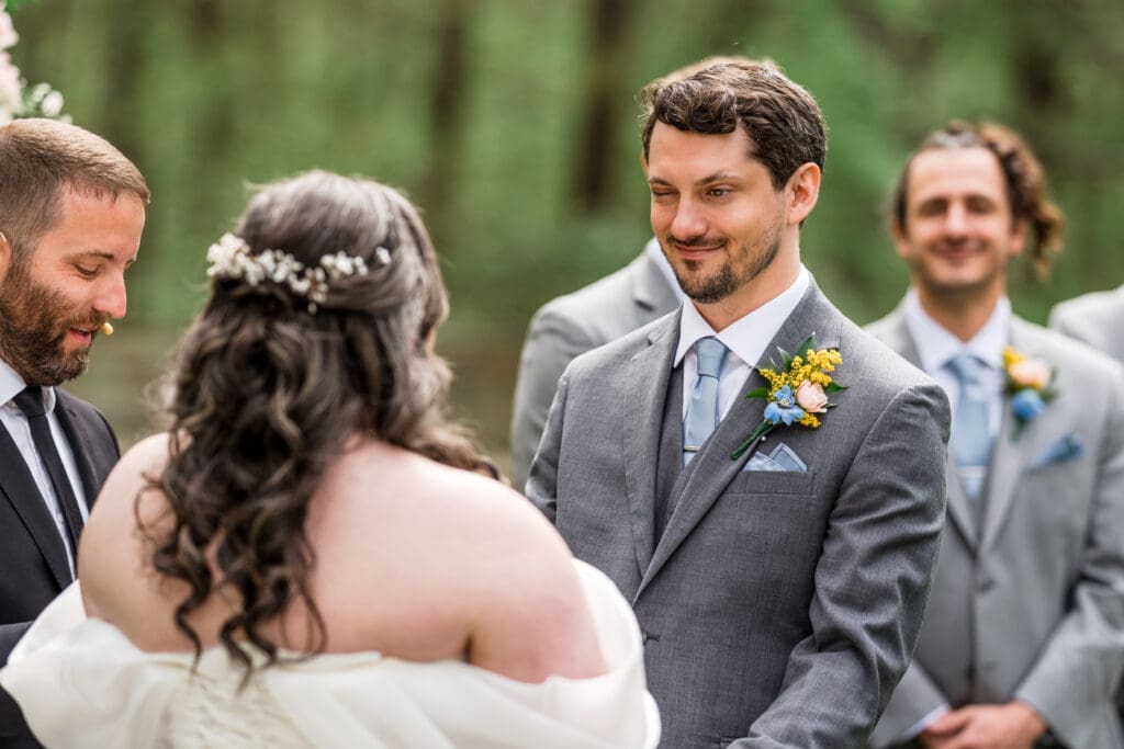 The groom winks at his bride during their wedding at the Dempsey Event Center in Delaware, Ohio.