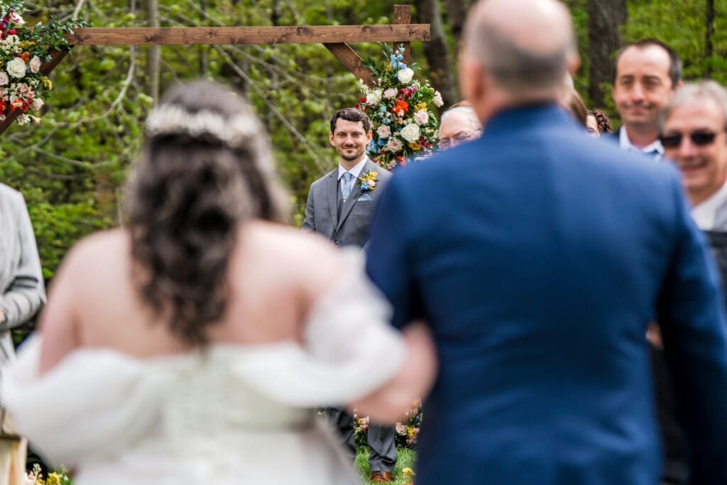 The groom reacts to seeing his bride at their wedding at the Dempsey Event Center in Delaware, Ohio.
