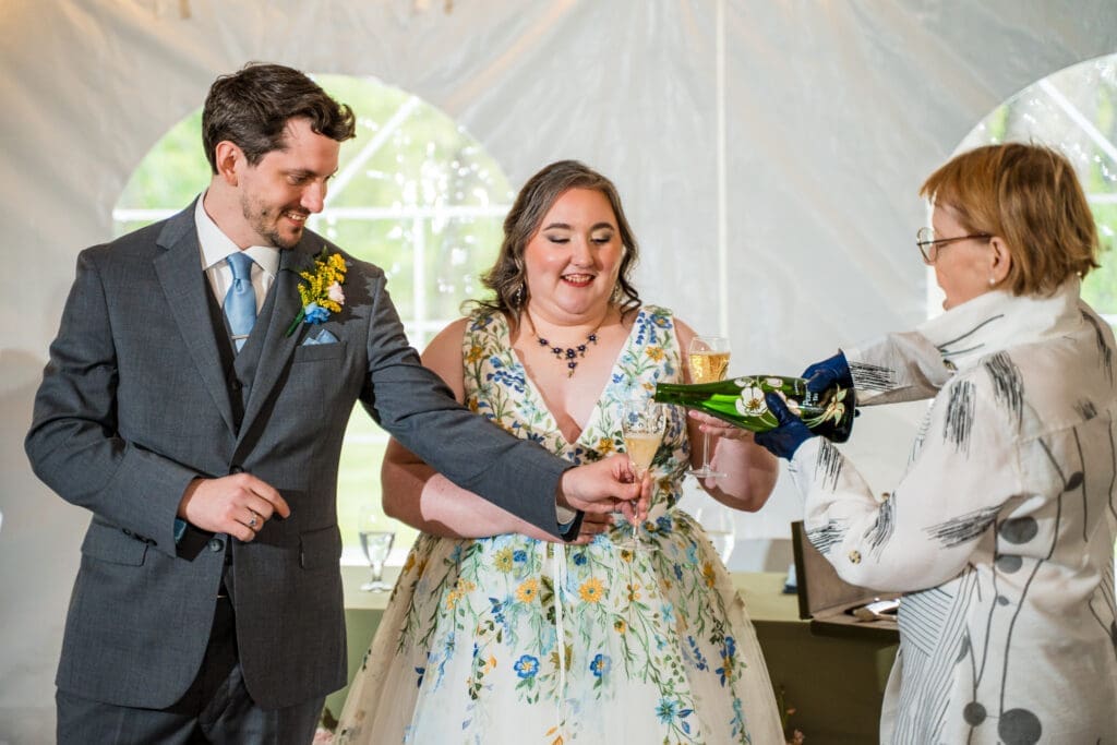Pouring champagne after the saboring at the Dempsey Event Center in Delaware, Ohio.