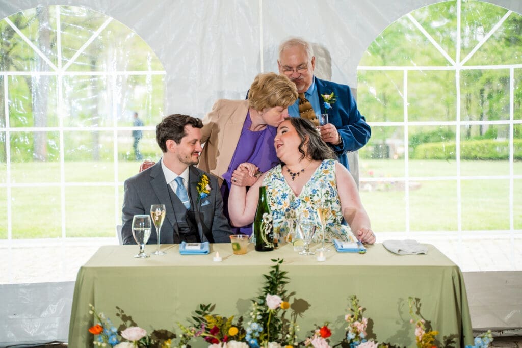 The Groom's mom kisses the Bride's forehead at the Dempsey Event Center in Delaware, Ohio.