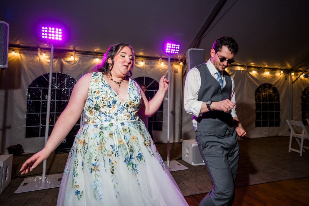 Wedding couple dances at their tented wedding reception at the Dempsey Event Center in Delaware, Ohio.