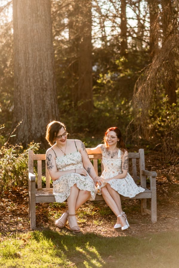 A LGBTQ+ couple laughing while on a bench at Inniswoods Metro Gardens