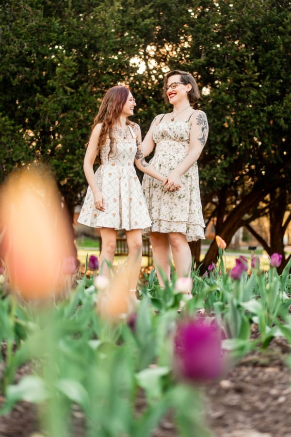 A LGBTQ+ couple laughing in a field of tulips at Inniswoods Metro Gardens