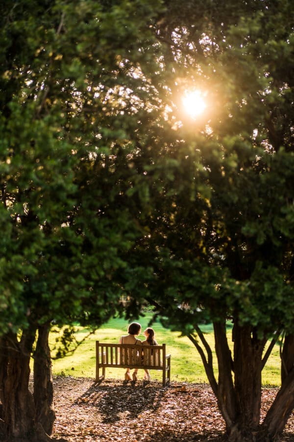 An artistic engagement photo of a LGBTQ+ couple at Inniswoods Metro Gardens at golden hour