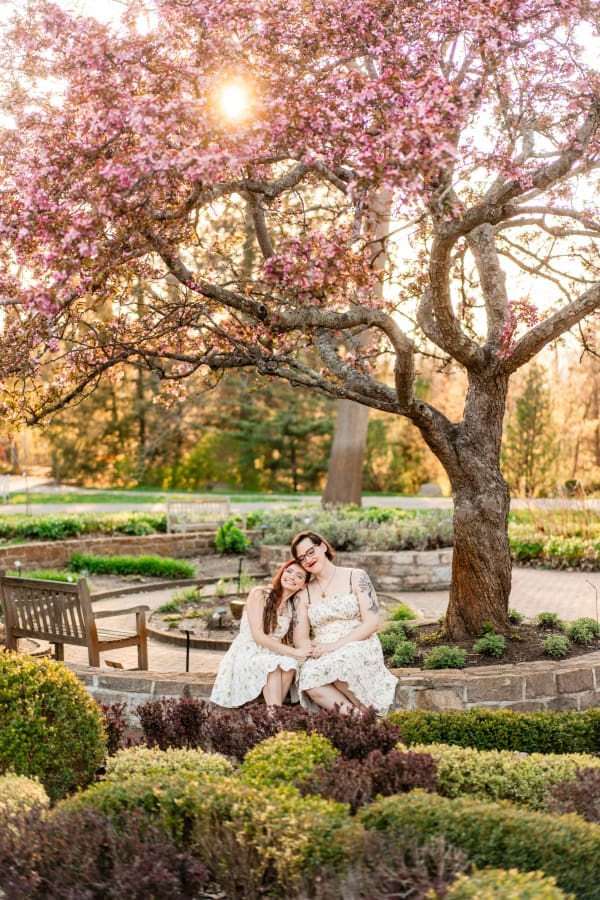 A spring engagement photo of an LGBTQ+ couple at Inniswoods Metro Gardens