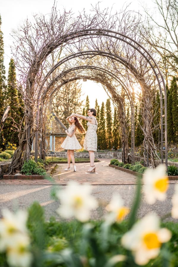 An LGBTQ+ couple dance at Inniswoods Metro Gardens during the springtime