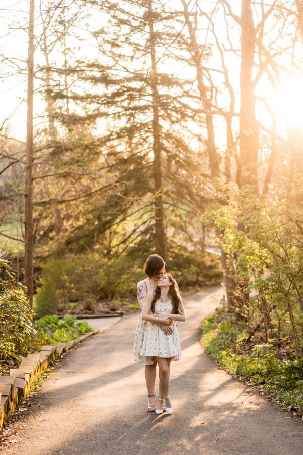 A golden hour engagement photo of a LGBTQ+ couple at Inniswoods Metro Gardens