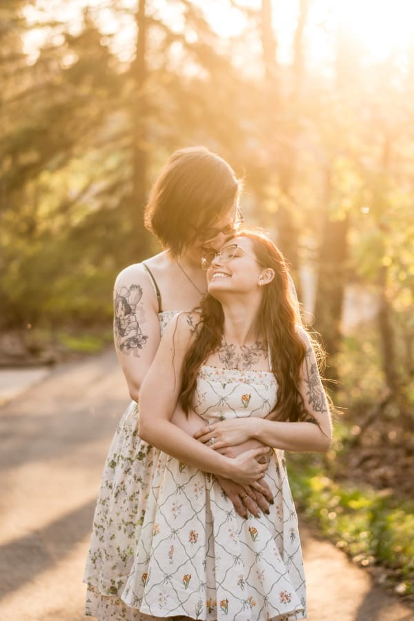 A golden hour engagement photo of a LGBTQ+ couple at Inniswoods Metro Gardens