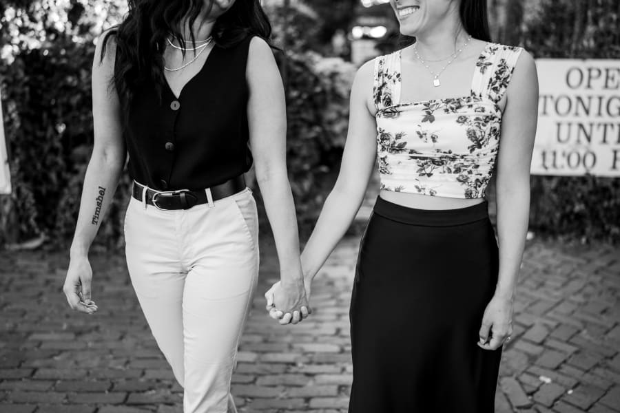 Two women hold hands