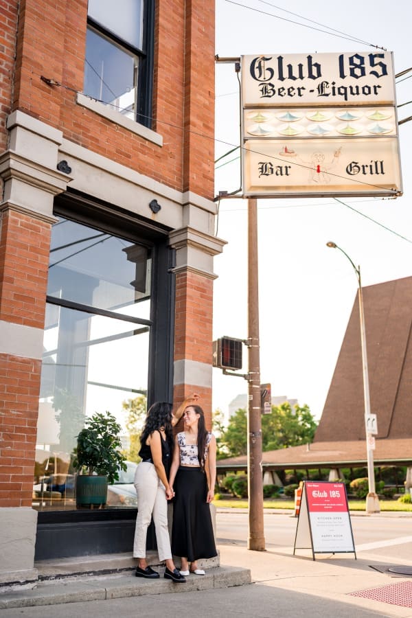Engaged couple stands outside of Club 185 in German Village