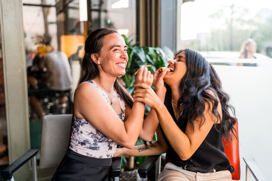 Silly engagement photo of the couple feeding each other at Club 185 in German Village