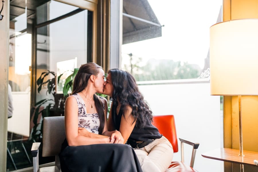 Romantic engagement photo of two women kissing at Club 185 in German Village