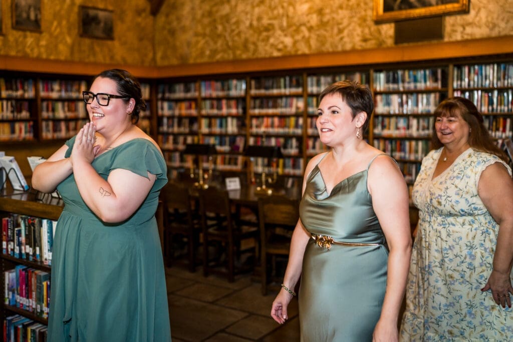 First look with bridesmaids at a Columbus Ohio LGBTQ+ wedding at Wagnalls Memorial Library