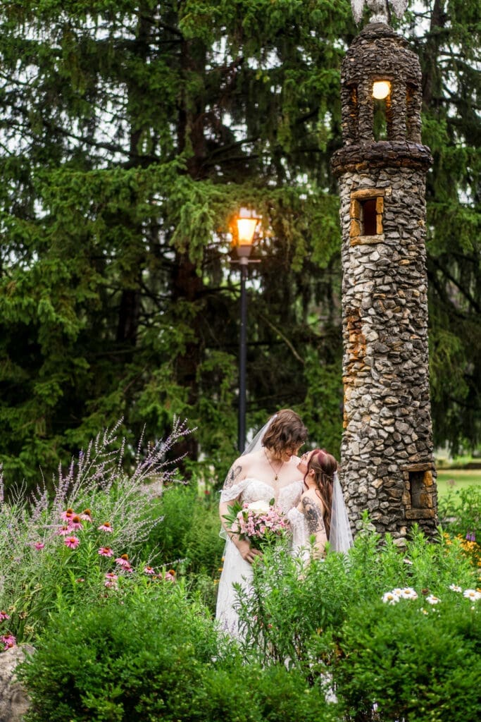 Couple portrait of two brides in the gardens at a Columbus Ohio LGBTQ+ wedding at Wagnalls Memorial Library