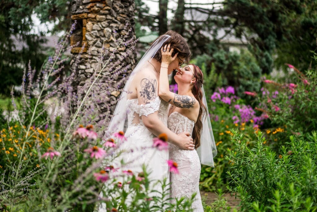 Couple portrait of two brides in the gardens at Wagnalls Memorial Library