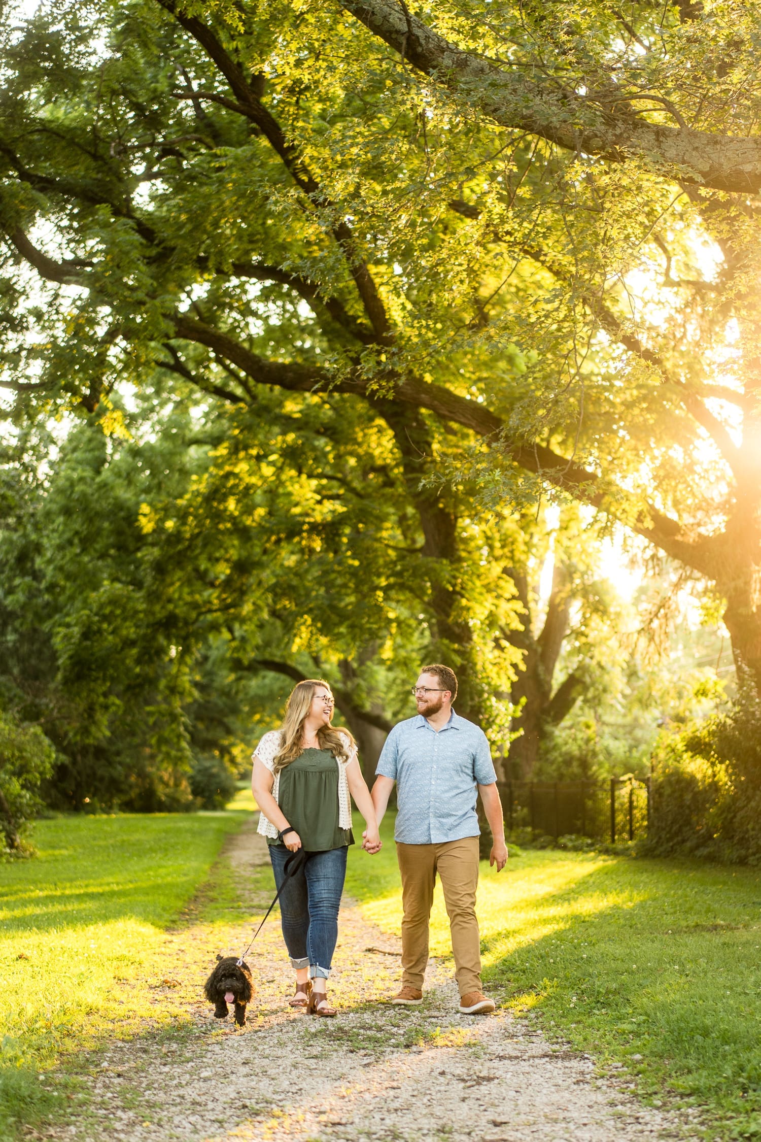 Golden hour engagement photos at the Columbus Park of Roses with their dog.