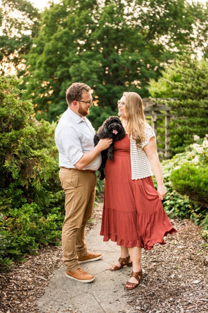 Engagement photos at the Columbus Park of Roses with their dog.