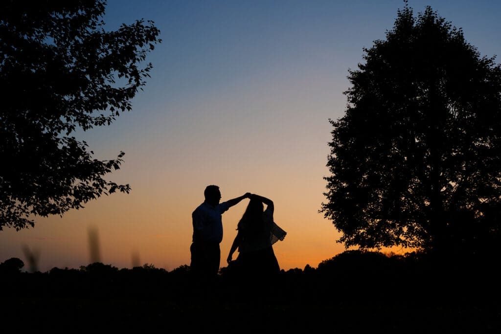Sunset silhouette engagement photos at the Columbus Park of Roses.