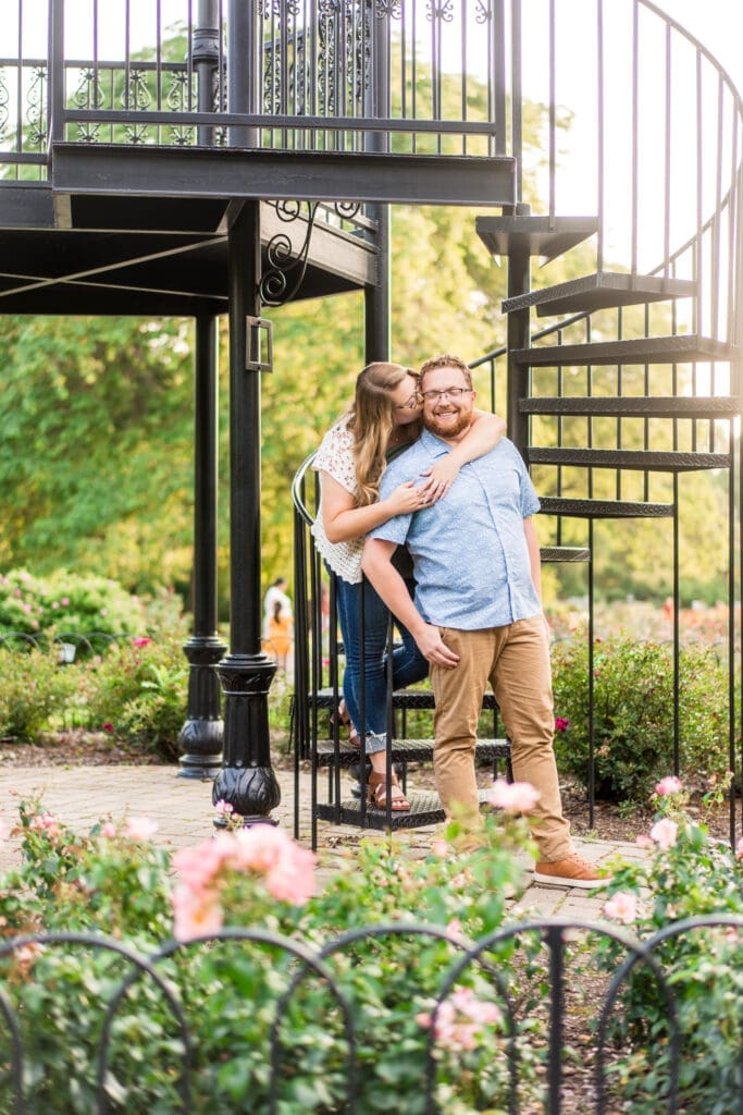 Engagement photo at the iron tower at Columbus Park of Roses.